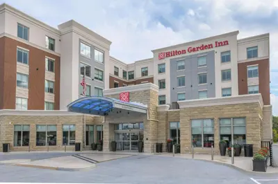 a hospital building with an umbrella in front of it at Hilton Garden Inn Cincinnati Midtown in Cincinnati