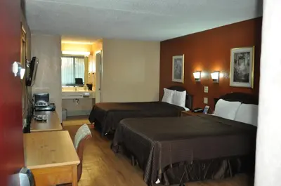 a hotel room with two beds and a bathroom at Bestway Inn - Madison in Madison