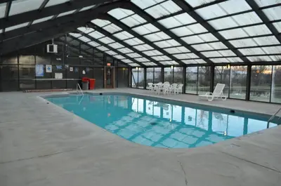 a large swimming pool in a building with a glass ceiling at Bestway Inn - Madison in Madison