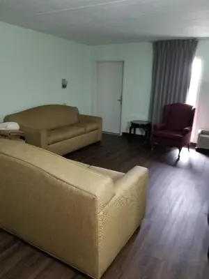 a living room with a couch and a chair at Bestway Inn - Madison in Madison