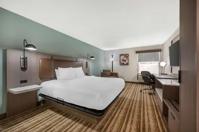 a hotel room with a large bed and a desk at Best Western Plus Richmond Indiana I-70 in Richmond