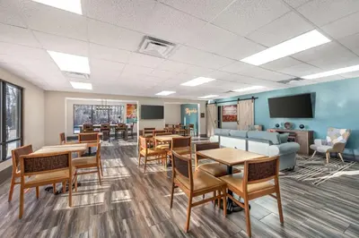 a waiting room with tables and chairs and a couch at Best Western Plus Richmond Indiana I-70 in Richmond
