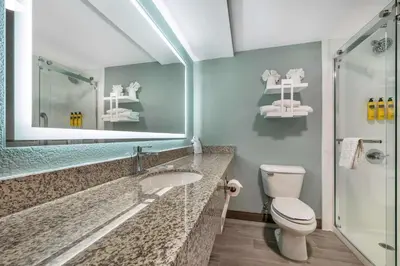 a bathroom with a sink and a toilet and a mirror at Best Western Plus Richmond Indiana I-70 in Richmond