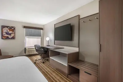 a hotel room with a desk and a tv at Best Western Plus Richmond Indiana I-70 in Richmond