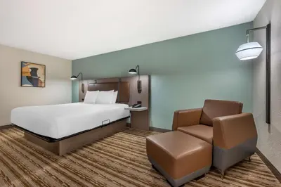 a hotel room with a bed and a chair at Best Western Plus Richmond Indiana I-70 in Richmond