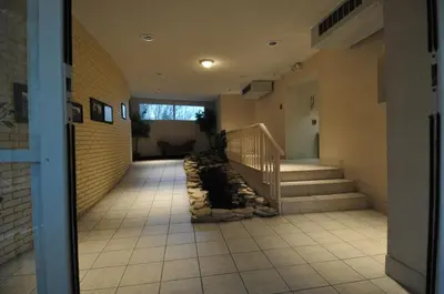 a hallway with a staircase in a building at Hillside Inn in Madison