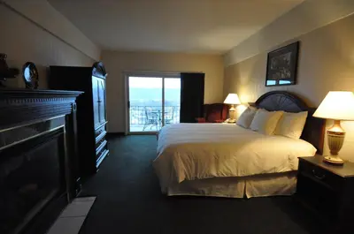 a hotel room with a bed and a balcony at Hillside Inn in Madison