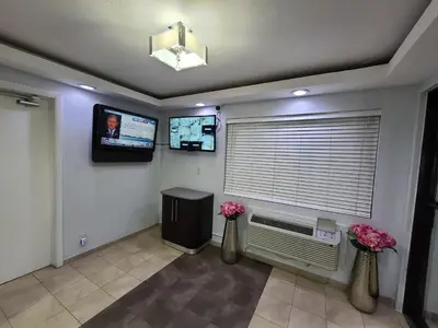 a room with a window with a television and flowers at Motel 6-Dayton, OH in Dayton