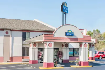 a building with a sign for a store at Days Inn & Suites by Wyndham Youngstown / Girard Ohio in Girard