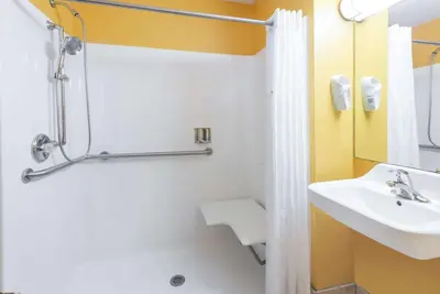 a bathroom with a sink and a shower at Days Inn & Suites by Wyndham Youngstown / Girard Ohio in Girard
