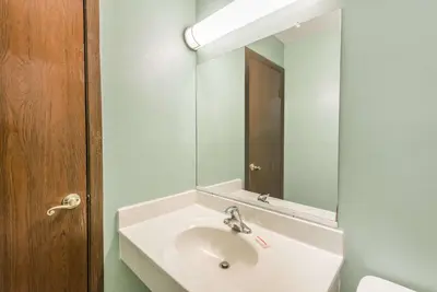 a bathroom with a sink and a mirror at Days Inn & Suites by Wyndham Youngstown / Girard Ohio in Girard