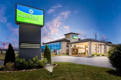 a sunbury stay sign in front of a building at SureStay by Best Western Grayson in Grayson