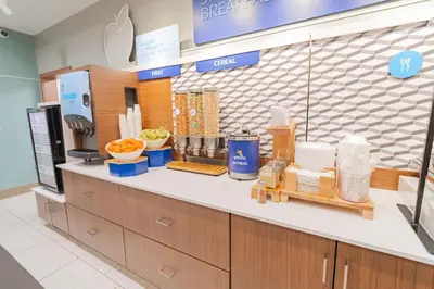 a kitchen with a counter with food on it at Holiday Inn Express & Suites - Marion by IHG in Marion