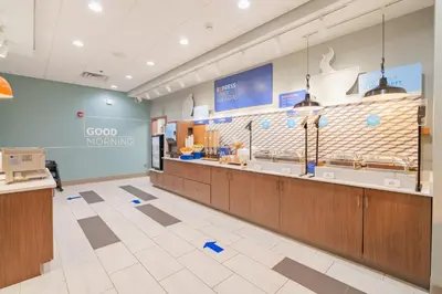 a food court with a counter in a store at Holiday Inn Express & Suites - Marion by IHG in Marion