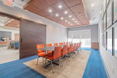 a conference room with a table and chairs at Holiday Inn Express & Suites - Marion by IHG in Marion
