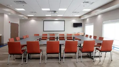 a conference room with a large table and chairs at Holiday Inn Express & Suites - Marion by IHG in Marion