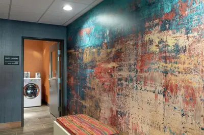 a room with a wall that has a painting on it at Hampton Inn & Suites Xenia Dayton in Xenia