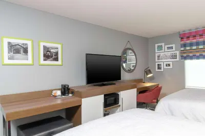 a bedroom with a desk with a tv and a bed at Hampton Inn & Suites Xenia Dayton in Xenia