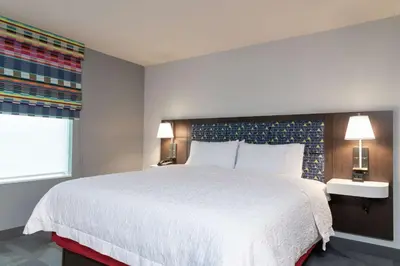a bedroom with a large white bed and two lamps at Hampton Inn & Suites Xenia Dayton in Xenia