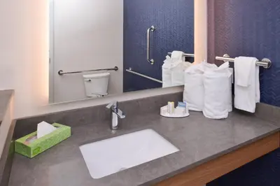 a bathroom with a sink and a mirror and towels at Fairfield Inn & Suites by Marriott Columbus Grove City in Grove City