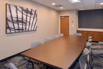a conference room with a wooden table and chairs at Fairfield Inn & Suites by Marriott Columbus Grove City in Grove City