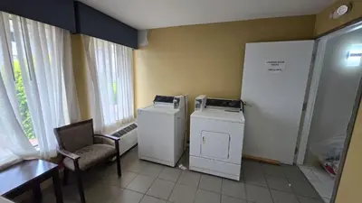 a room with two machines and a chair and a table at Copley Inn & Suites By OYO Akron OH in Akron