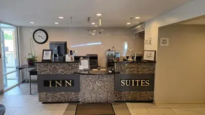 a counter in a store with a clock on the wall at Copley Inn & Suites By OYO Akron OH in Akron