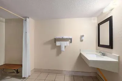 a bathroom with a sink and a mirror at Super 8 by Wyndham Fort Mitchell Cincinnati Area in Fort Mitchell
