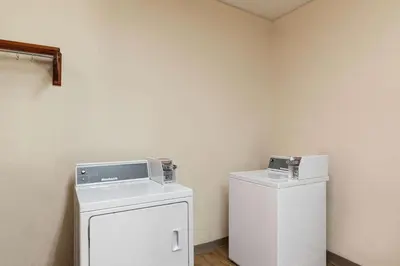 a laundry room with a washer and dryer at Super 8 by Wyndham Fort Mitchell Cincinnati Area in Fort Mitchell