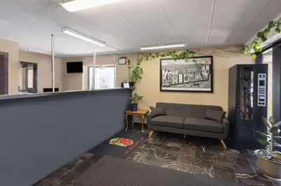 a waiting room with a couch in an office at Super 8 by Wyndham Fort Mitchell Cincinnati Area in Fort Mitchell