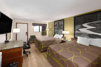a hotel room with two beds and a flat screen tv at Super 8 by Wyndham Fort Mitchell Cincinnati Area in Fort Mitchell
