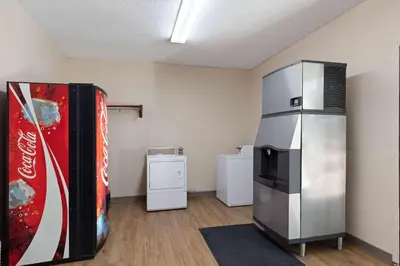 a room with a large refrigerator and a soda machine at Super 8 by Wyndham Fort Mitchell Cincinnati Area in Fort Mitchell