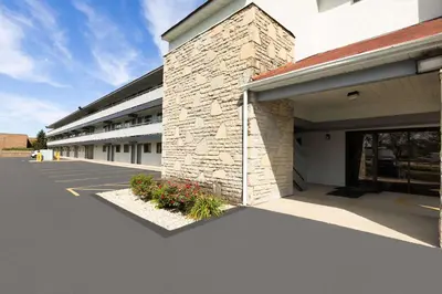 an empty parking lot in front of a building at Super 8 by Wyndham Fort Mitchell Cincinnati Area in Fort Mitchell