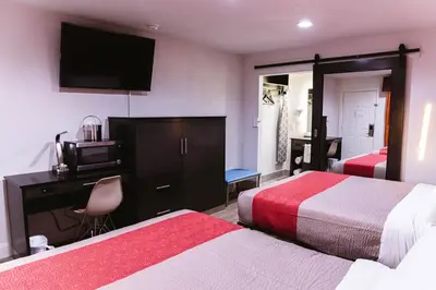 a hotel room with two beds and a desk and a television at Motel 6 Bellville, OH in Bellville