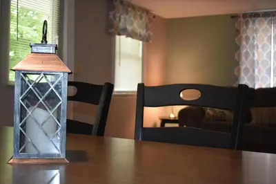 a lantern sitting on top of a wooden table at Cozy 2 Bedroom House in Adrian