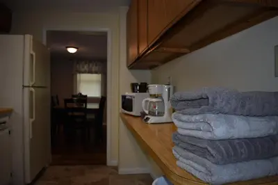 a pile of towels sitting on a counter in a kitchen at Cozy 2 Bedroom House in Adrian