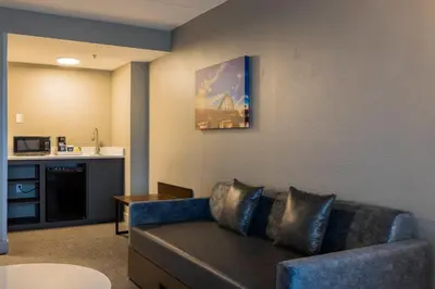 a living room with a couch and a kitchen at Four Points by Sheraton Columbus-Polaris in Columbus