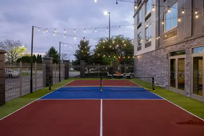 a tennis court in front of a building at Four Points by Sheraton Columbus-Polaris in Columbus