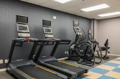 a gym with several treadmills and cardio machines at Four Points by Sheraton Columbus-Polaris in Columbus