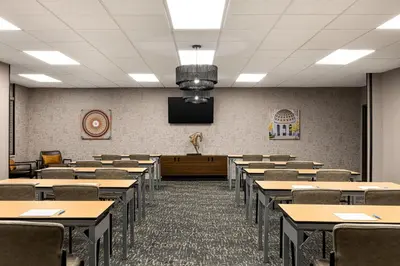 a classroom with tables and chairs and a tv at Four Points by Sheraton Columbus-Polaris in Columbus
