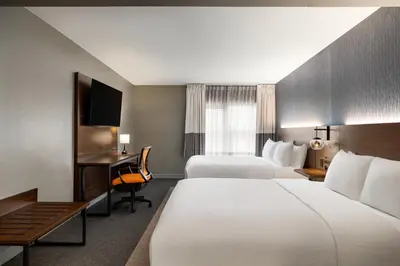 a hotel room with two beds and a desk at Four Points by Sheraton Columbus-Polaris in Columbus