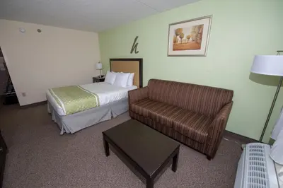 a hotel room with a bed and a couch at Hope Hotel and Richard C. Holbrooke Conference Center in Fairborn