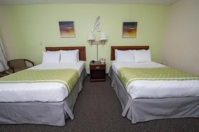 two beds in a hotel room with two at Hope Hotel and Richard C. Holbrooke Conference Center in Fairborn