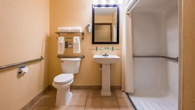 a bathroom with a toilet and a sink and a shower at Best Western Muncie in Muncie