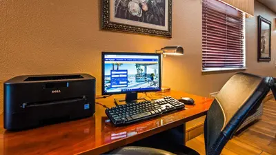 a desk with a computer and a printer on it at Best Western Muncie in Muncie