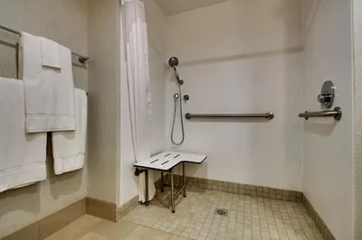 a bathroom with a shower and a small table at Holiday Inn Express - Lexington East - Winchester by IHG in Winchester