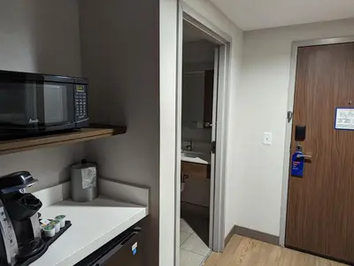 a small kitchen with a microwave and a bathroom at Holiday Inn Express - Lexington East - Winchester by IHG in Winchester