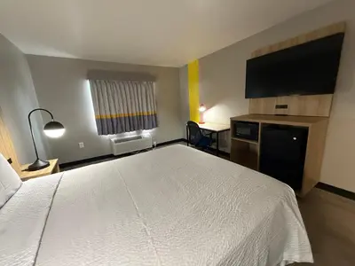 a bedroom with a large white bed in a room at Super 8 by Wyndham Richfield Cleveland in Richfield