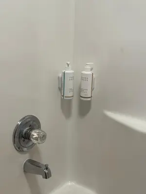 a bathroom sink with two soap bottles on it at Super 8 by Wyndham Richfield Cleveland in Richfield