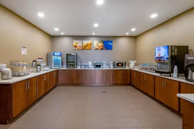 a room with a coffee shop with a counter at Comfort Suites Columbus Airport in Columbus